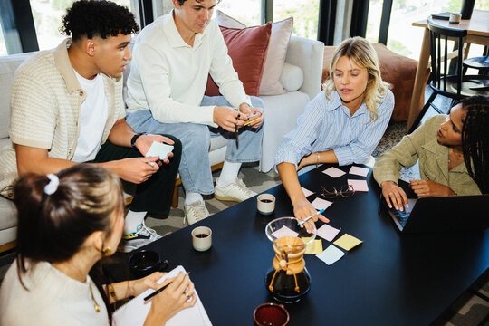 Young professionals collaborating at a modern business meeting in an office environment