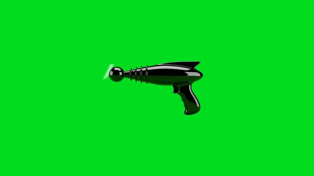 A shiny black retro sci-fi ray gun isolated on a bright green background