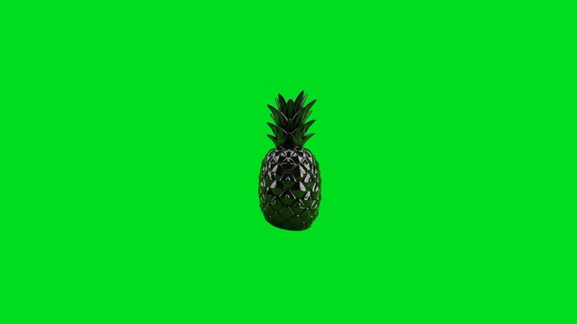A glossy black pineapple isolated against a vibrant green screen background
