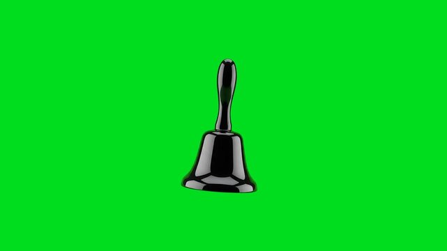 A shiny black metal hand bell isolated against a vibrant green background