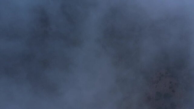 Dense fog and clouds obscure the landscape creating mysterious atmospheric conditions under overcast sky for weather nature abstract atmosphere drone photography footage stock platform ready media