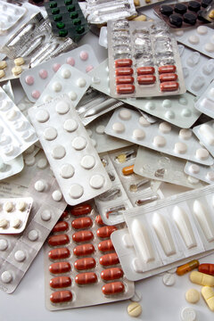 Several tablets and capsules in blister packs, close-up