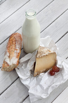 Sheep cheese, milk and bread on wooden table