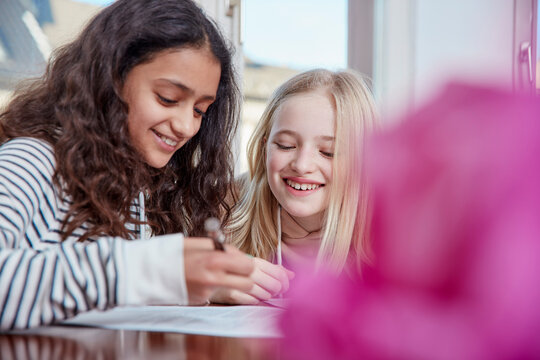Two girls doing homework together