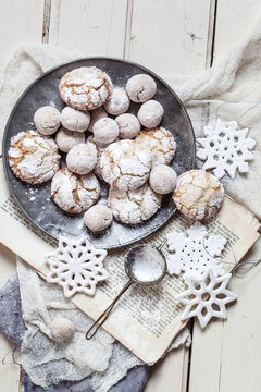 Home-baked Christmas cookies with powdered sugar on old book