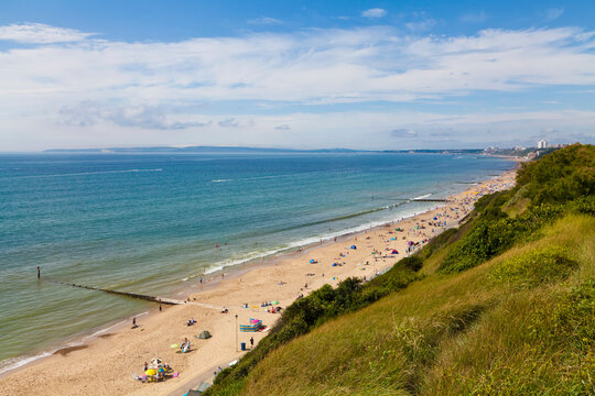 Bournemouth beach borders the blue sea in Dorset England