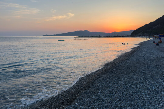 Colorful Sky and Seascape with Alps in Background in Chiavari Village during a Sunny Summer Evening. Genoa Province, Italy