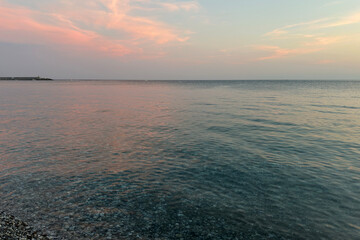 Fototapeta premium Beautiful Seascape with Pink Clouds Reflected on Water. View from Chiavari Village during a Summer Sunset. Genoa Province, Italy
