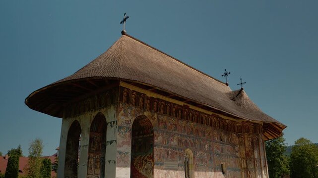 Discover Humor Monastery in Bucovina Romania. This place features old paintings that depict various historical and religious themes. Enjoy the stunning architecture.
