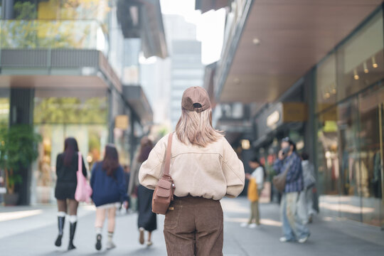 woman traveler travel in Chengdu city. Happy Tourist sightseeing in Taikoo Li Chengdu, located in the Jinjiang District, near the Chunxi Road. Famous landmark for tourism attraction in Sichuan, China
