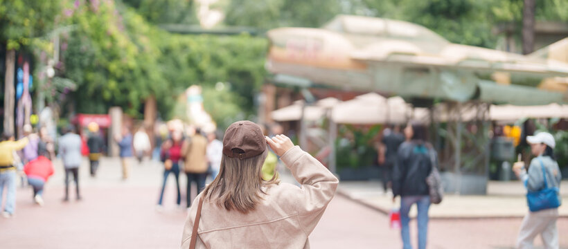 Happy woman traveler travel in Chengdu city. Tourist sightseeing and shopping in Eastern Suburb Memory or Dongjiao Ji Yi. Famous Landmark for tourism attraction in Sichuan, China