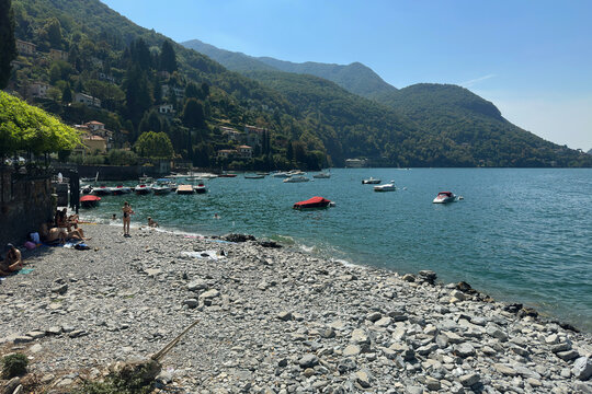 Stone Beach on Beautiful Como Lake during a Sunny Summer Afternoon. Faggeto Lario Village, Como Province, Italy