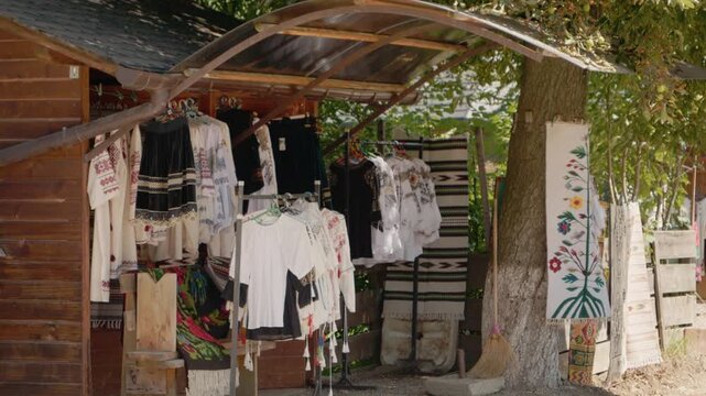 Visitors can explore a stall in Bucovina that offers traditional Romanian clothes. These garments represent the local culture and heritage of the region.