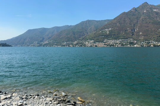 Beautiful Stone Beach on Como Lake during a Sunny Summer Day. Faggeto Lario, Como Province, Italy