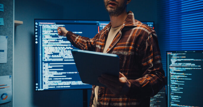 Confident Caucasian male engineer presents software strategy during late night work in office. Experienced tech consultant expertise, Innovative startup leader, Professional online conference concept.