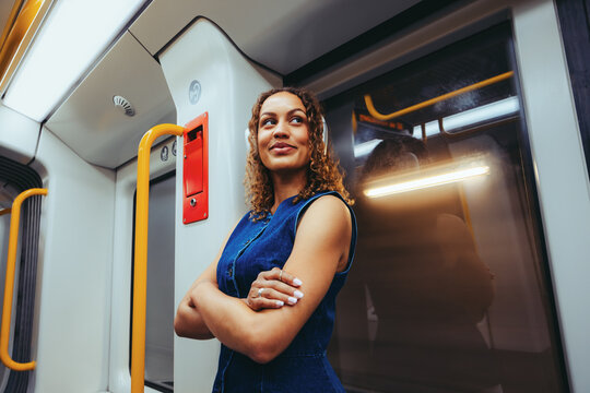 Thoughtful woman stands in the metro during city commute