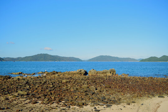 Scenic Rocky Coastline and Deep Blue Sea Under Clear Sky
