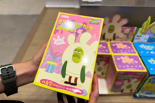 PENANG, MALAYSIA - JUL 03, 2026: Hand holding SpongeBob SquarePants Bikini Bottom Buddies blind box inside Pop Mart retail store.