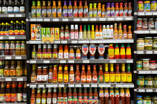 PENANG, MALAYSIA - JUL 03, 2026: Assorted hot sauces and condiments displayed on supermarket grocery retail shelves.