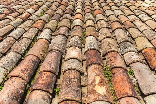 Aged terracotta roof tiles texture on traditional medieval building in Rupit, Catalonia, Spain