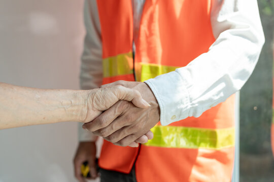 Construction team hands shaking greeting start up plan new project contract in office center at construction site, industry ,architecture, partner, teamwork, agreement, property, contacts.