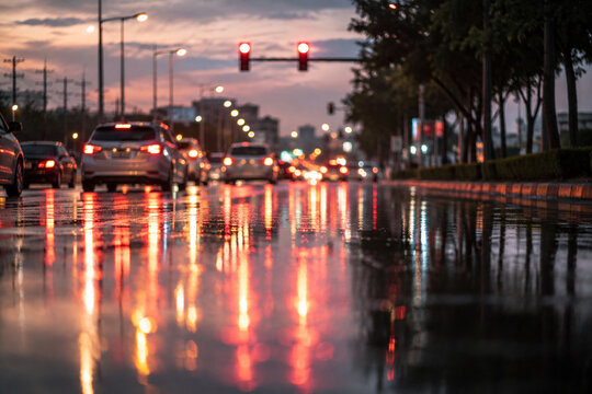 AI generated traffic lights reflecting wet streets during evening rush hour cars urban traffic showing rainy weather city commuting colorful road reflections