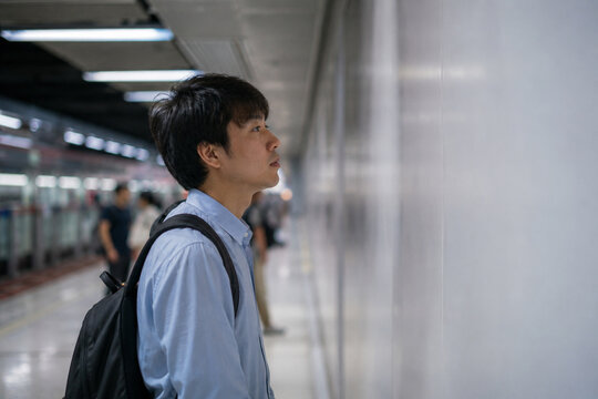 AI generated commuter staring at platform wall after train delay announcement showing frustration waiting uncertainty everyday challenges of urban public transport