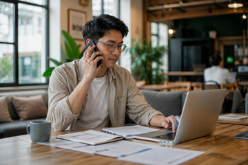 Fototapeta premium AI generated freelancer balancing work between phone laptop shared workspace showing remote work multitasking digital communication flexible modern lifestyle