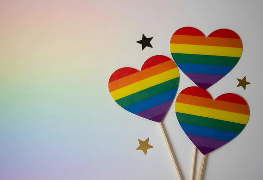 Lgbtq+ pride and equality concept, rainbow hearts with stars on a gradient background, diversity and inclusion celebration