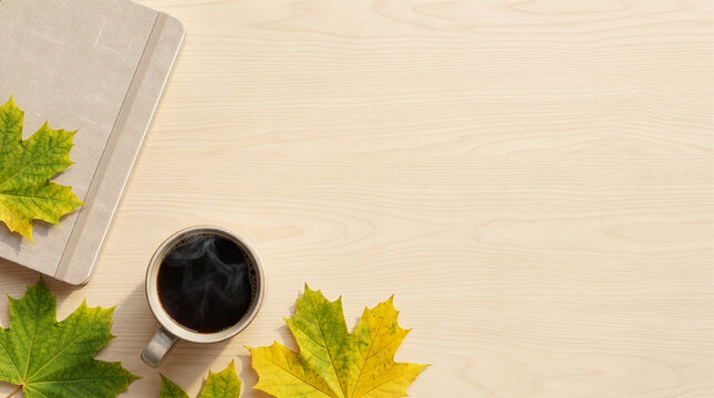 Early autumn workspace flat lay with coffee leaves and blank copy space
