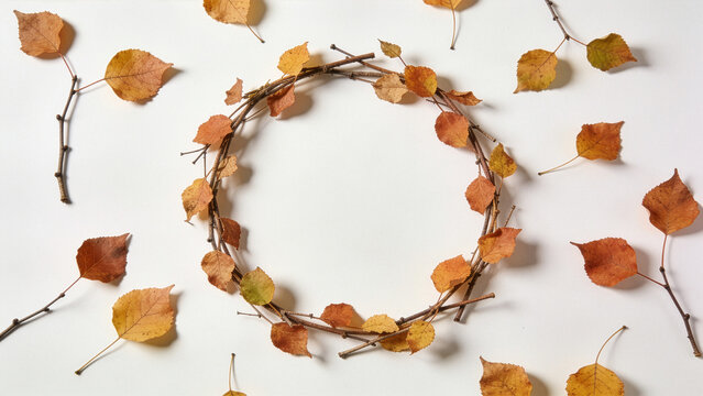 Delicate circular autumn leaf wreath flat lay with empty center for text