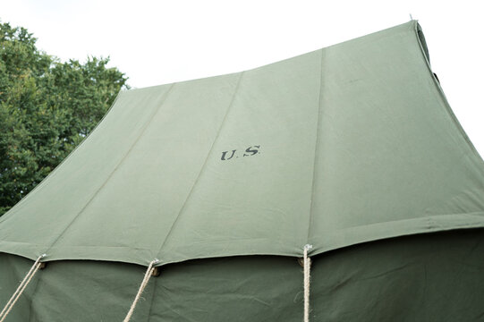 Newly erected canvas US Army tent of the WW2 era showing the guying ropes and US stamp on the roof. Used for a WW2 reenactment festival in the UK.
