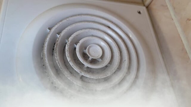 Smoke enters the exhaust fan showing how air moves in a room