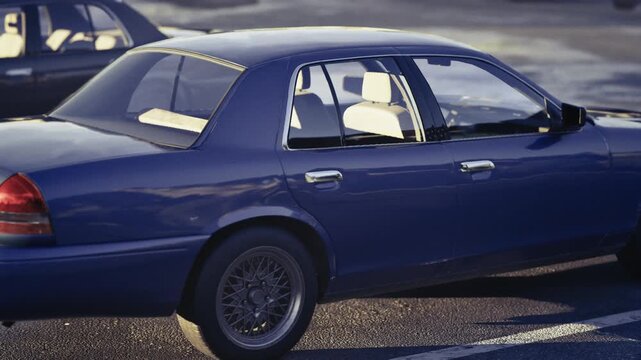 Empty sedan interior bathed in sunlight, leather upholstery and crisp dashboard lines with chrome trim, clear glass windows casting soft highlights