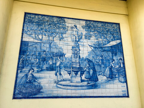 Traditional blue and white azulejo tile panel is located on the market's facade. Close-up. Funchal. Madeira. Portugal.