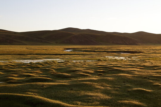 Sunrise Over Wet Grassland and Rolling Hills in Tsagaan, Arkhangai Province, Mongolia