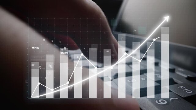 A close-up of hands typing on a keyboard, set against a backdrop of digital financial graphs and data, illustrating growth and investment concepts in the business world. Copula