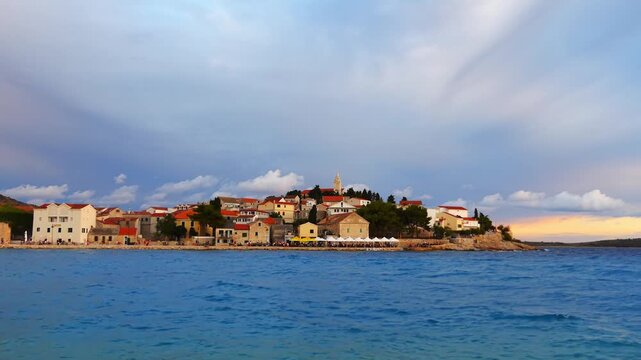 PRIMOSTEN, CROATIA - JULY 25 2017: Primosten (Capocesto) is village and municipality in Sibenik-Knin County, Croatia on Adriatic coast. Evening time. People walk around city.