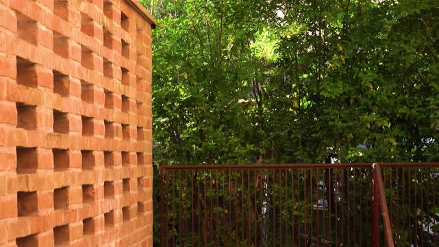 Brick wall in the middle of some trees. Bassano del Grappa, Vicenza province, Veneto, northern Italy.