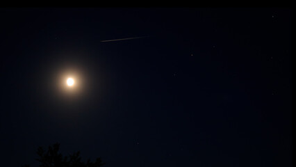 Moon on a night sky with landscape mountain silhouettes. © astrosystem