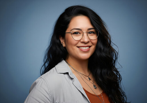 Portrait of a charming young asian woman wearing glasses standing down the street and looking at the camera.
