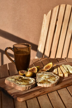 Rustic Mediterranean breakfast with figs, honey and cheese served on a terrace
