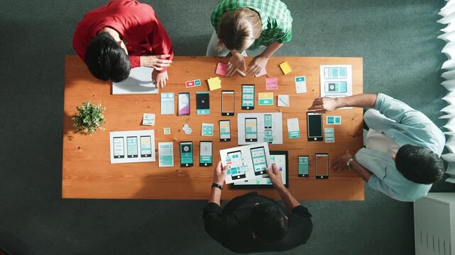 Top view of smart software developer planning software development. Skilled programmer team brainstorming and designing Ux UI design for mobile phone interface or digital creative design. Convocation.