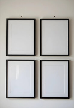 Blank picture frames on a white wall, home decor and interior design concept, customizable art display for gallery wall