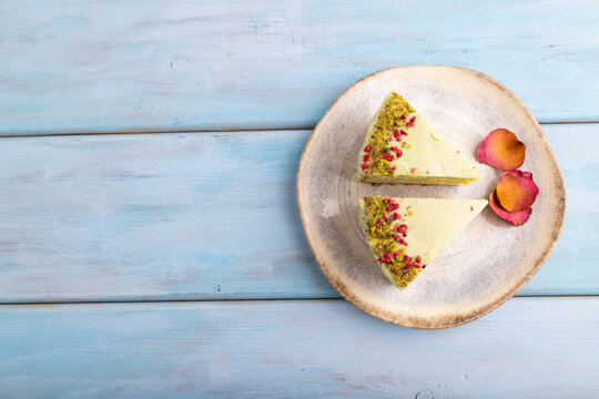 Pistachio green cake on blue wooden, copy space, top view.