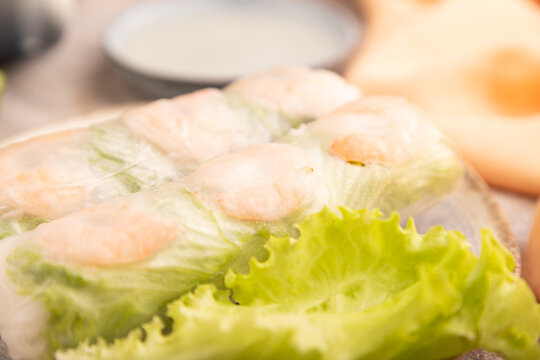 Vietnamese shrimp spring rolls on brown concrete. side view, close up, selective focus