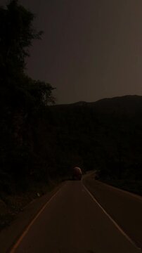 Scenic road footage showing the warm evening sun over lush forested hills along the route from the Manakamana Temple area toward Kathmandu, Nepal. The video captures a peaceful mountain landscape