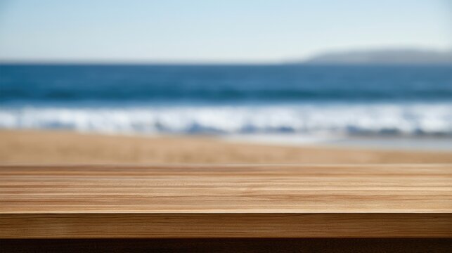 Empty wooden table with blurred beach, ocean waves, and sand backdrop