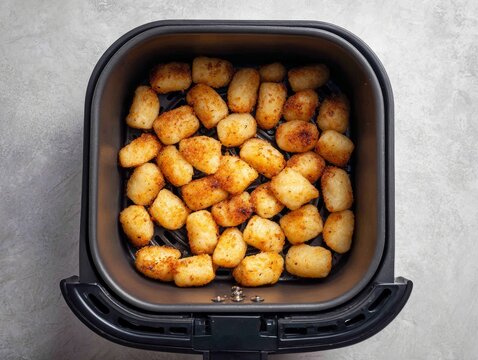 Crispy golden tater tots cooked inside a modern air fryer