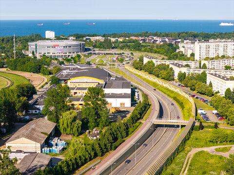 Gdansk, Poland - 15 July 2026: Aerial view of Ergo Arena and the surrounding urban landscape in the Oliwa district with a highway and the Baltic Sea in the background.